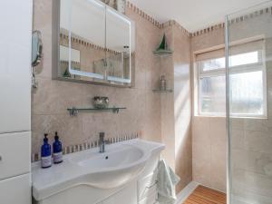 a bathroom with a sink and a mirror at 7 The Cedars in Wotton-under-Edge +26 photos