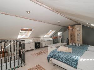 a bedroom with two beds in a attic at 7 The Cedars in Wotton-under-Edge