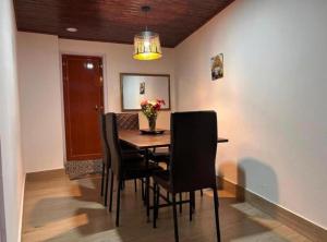 a dining room with a table and chairs at The Boho Darjeeling in Darjeeling