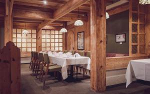 a dining room with a white table and chairs at Mountain Plaza Hotel in Davos