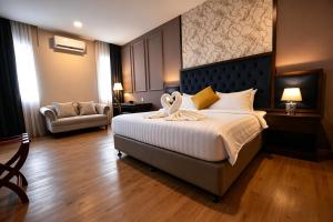 a bedroom with a large bed with a large headboard at The Leith in George Town