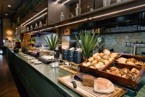 a bakery with lots of bread and other foods at Hotel ROMY by AMANO in Berlin