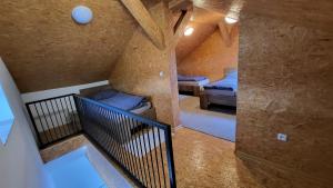 an attic room with two beds and a staircase at Apartmán u kolejí A in Kašnice