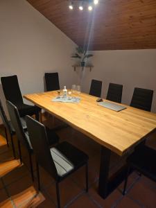 a conference room with a wooden table and chairs at GreenHell Stays Müsch - Nürburgring in Müsch