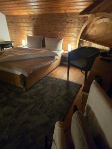 a bedroom with a bed and a chair in a cabin at GreenHell Stays Müsch - Nürburgring in Müsch +23 photos