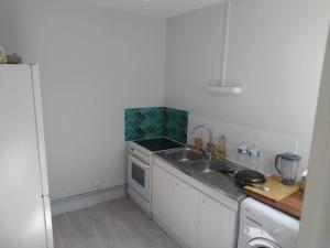 a small kitchen with a sink and a stove at Private Quiet Place in Dijon