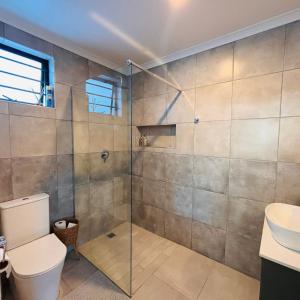a bathroom with a shower with a toilet and a sink at Bonnie Doon Luxury Studio in Bunkers Hill +5 photos