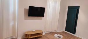 a room with a flat screen tv on a wall at Studio à 5 minutes des Musées in Grasse +6 photos