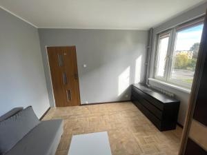 a living room with a couch and a window at U Damiana in Gdańsk