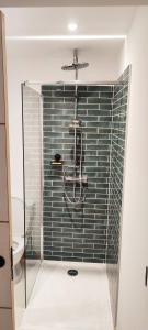 a shower with a glass door in a bathroom at Studio à 5 minutes des Musées in Grasse