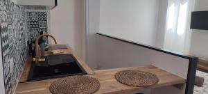 a kitchen with a wooden table and a sink at Studio à 5 minutes des Musées in Grasse