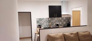a kitchen with black cabinets and a counter top at Studio à 5 minutes des Musées in Grasse