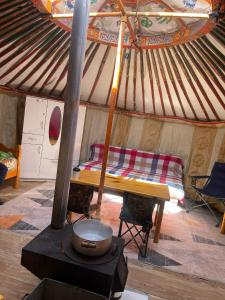 a room with a bed in a yurt with a stove at Yurt near terelj in Nalayh