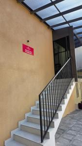 a red sign on the side of a building with stairs at Mansori Residency in Cochin