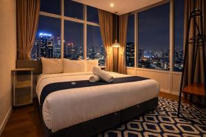 a hotel room with a bed with a view of a city at KL Suites Apartment At Vortex in Kuala Lumpur