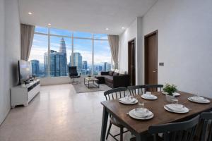 a living room with a table and chairs and a large window at KL Suites Apartment At Vortex in Kuala Lumpur