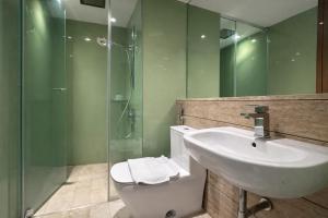 a bathroom with a toilet and a sink and a shower at KL Suites Apartment At Vortex in Kuala Lumpur +81 photos