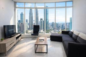a living room with a couch and a large window at KL Suites Apartment At Vortex in Kuala Lumpur