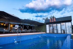 a swimming pool in front of a hotel at Eza Hotel in Kigali