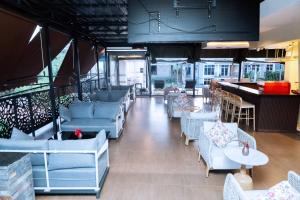 a restaurant with blue couches and tables and a bar at Eza Hotel in Kigali