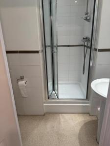 a bathroom with a shower and a sink at Cosy House in Reading