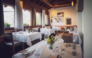 a dining room with tables with white tablecloths at Hotel Waldhuus in Davos