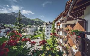 a view of a city with flowers on buildings at Hotel Waldhuus in Davos