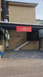 an entrance to a building with a red sign on it at Mansori Residency in Cochin