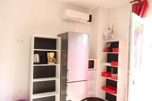 a refrigerator in a room with shelves at Holiday Home Desire in Kras