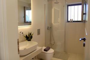 a bathroom with a sink and a toilet and a shower at SUMU Luxury Apartment in Lefkada +17 photos