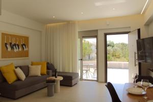 a living room with a couch and a table at SUMU Luxury Apartment in Lefkada