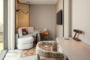 a living room with a couch and a chair and a table at W Riyadh - KAFD in Riyadh