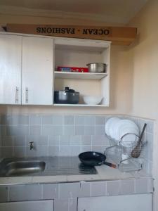 a kitchen counter with a sink and a bowl on it at Ibus Nawi Homes 2 in Lodwar