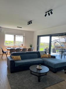 a living room with a blue couch and a table at Blackberry Guesthouse in Jastrebarsko