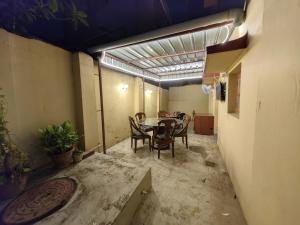 a room with a table and chairs in a building at Evara Stays Backpackers Hostel in Kolkata