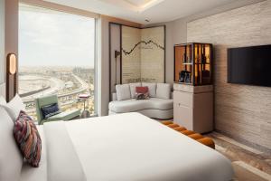 a hotel room with a bed and a tv at W Riyadh - KAFD in Riyadh
