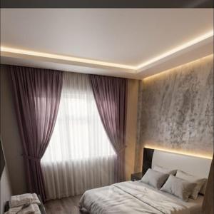 a bedroom with a bed and a large window at Old City Cafe in Brăila