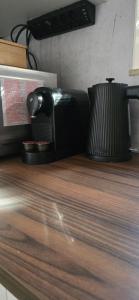 a coffee maker sitting on top of a wooden counter at The Rose in Rheinhausen