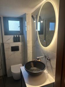 a bathroom with a black sink and a mirror at Peaceful modern holiday vila in Skala Fourkas +15 photos