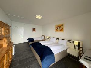 a hotel room with a bed and a desk and a bed sidx sidx sidx sidx at Al Ponte in Cademario