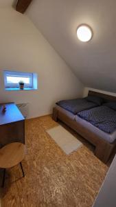 a small room with a bed and a table at Apartmán u kolejí D in Kašnice
