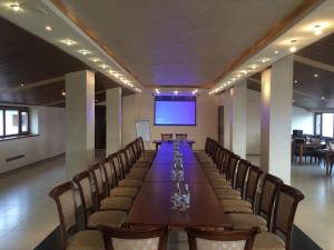 a conference room with a long table and chairs at Capital Hotel in Yerevan