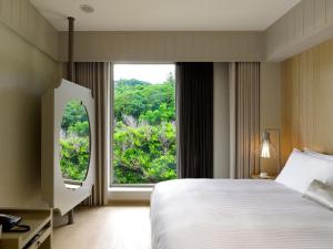 a bedroom with a large bed and a large window at Gloria Manor in Kenting +37 photos