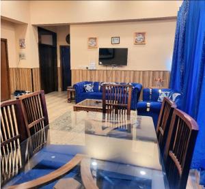 a living room with a glass table and chairs at Panorama Luxury House in Nathia Gali