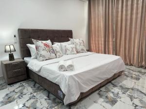 a bedroom with a large bed with shoes on it at The calm villa in Kandana