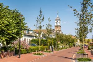 a street with a building with a clock tower at Estrela Do Norte in De Cocksdorp +11 photos