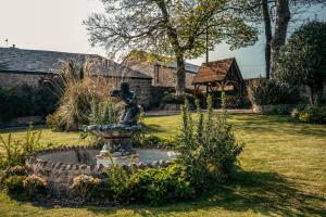 a statue in the middle of a garden at South Causey Inn in Stanley
