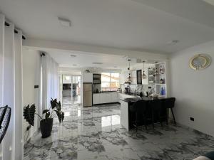 a kitchen with a table and chairs on a tile floor at The calm villa in Kandana