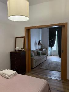 a living room with a bed and a couch at Casa & Caminho AL in Velas