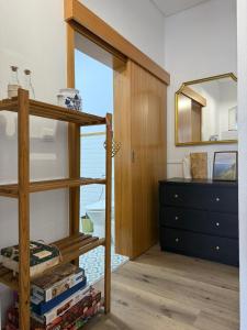 a bedroom with a bunk bed and a dresser at Casa & Caminho AL in Velas +7 photos